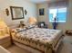 Cozy bedroom with a comfortable bed, decorative mirror, and soft lighting, creating a relaxing atmosphere at 163 Sweet Cir, Winter Haven, FL 33884