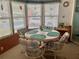 Dining room with round table and seating for four in front of a bay window at 163 Sweet Cir, Winter Haven, FL 33884