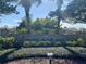 Community entrance sign surrounded by mature landscaping and trees, creating a welcoming feel at 163 Sweet Cir, Winter Haven, FL 33884