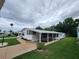 Single-story residence with carport, well-manicured lawn, and mature trees, showcasing a serene community setting at 163 Sweet Cir, Winter Haven, FL 33884