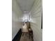Bright hallway with beige carpet and wood paneled walls leading to sunroom at 163 Sweet Cir, Winter Haven, FL 33884
