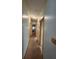Hallway with multiple doors that provides seamless access to other areas of the home at 163 Sweet Cir, Winter Haven, FL 33884