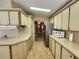 Kitchen leading to a dining room with stainless steel refrigerator at 163 Sweet Cir, Winter Haven, FL 33884