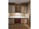 Convenient laundry area with storage cabinets above counter space for folding and organizing at 163 Sweet Cir, Winter Haven, FL 33884
