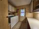 Functional laundry room with washer, dryer, cabinets, and a door to the outside at 163 Sweet Cir, Winter Haven, FL 33884