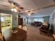 Inviting living room featuring plush sofas, ceiling fans, and an open layout to the dining area at 163 Sweet Cir, Winter Haven, FL 33884