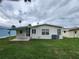 Features a tidy yard, air conditioning unit, and aluminum roof in a peaceful residential community at 163 Sweet Cir, Winter Haven, FL 33884