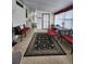 Bright sunroom with a black and beige floor rug, multiple windows, comfortable seating, and a charming table set at 163 Sweet Cir, Winter Haven, FL 33884