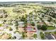 Aerial view of a home located in a neighborhood with golf course amenities, offering a picturesque and active lifestyle at 1654 Blossom Ter, The Villages, FL 32162