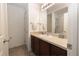 Bathroom features a large mirror, vanity with sink, and a shower with glass doors at 1654 Blossom Ter, The Villages, FL 32162