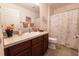 Well-lit bathroom featuring vanity with sink, a mirror and a shower behind a floral shower curtain at 1654 Blossom Ter, The Villages, FL 32162
