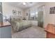 Cozy bedroom features carpeted floors, a ceiling fan, and a window with sheer curtains at 1654 Blossom Ter, The Villages, FL 32162