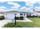 Charming single-story home features a well-manicured lawn and attached garage in a friendly neighborhood at 1654 Blossom Ter, The Villages, FL 32162