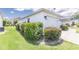 Well-maintained home exterior featuring manicured landscaping and a two-car garage, enhancing its curb appeal at 1654 Blossom Ter, The Villages, FL 32162