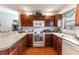 Bright kitchen showcasing wooden cabinets, modern appliances, and a functional layout at 1654 Blossom Ter, The Villages, FL 32162