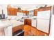 Well-lit kitchen featuring wooden cabinets, modern appliances, and ample countertop space at 1654 Blossom Ter, The Villages, FL 32162