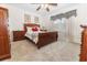 Comfortable bedroom with a cozy carpet, ceiling fan, and a large window for natural light at 1654 Blossom Ter, The Villages, FL 32162
