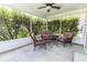 Screened-in patio features a comfortable seating arrangement, providing a relaxing space to enjoy the outdoors bug-free at 1654 Blossom Ter, The Villages, FL 32162