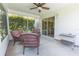Relaxing screened-in patio with cozy seating and sliding glass door access to inside for easy indoor-outdoor living at 1654 Blossom Ter, The Villages, FL 32162