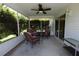 Relaxing screened porch with wicker furniture and a ceiling fan for comfortable outdoor living at 1654 Blossom Ter, The Villages, FL 32162