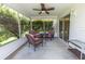 Relaxing screened porch with wicker furniture and a ceiling fan for comfortable outdoor living at 1654 Blossom Ter, The Villages, FL 32162
