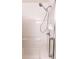 Bright and clean shower with white tile and a handheld shower head at 1654 Blossom Ter, The Villages, FL 32162
