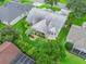 Aerial view of property with lush landscaping, patio and screened-in porch at 1889 Union Pl, The Villages, FL 32162