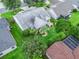 Aerial view of property with lush landscaping, patio and screened-in porch at 1889 Union Pl, The Villages, FL 32162