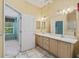 Bathroom featuring double vanity, tile floor, and high ceilings at 1889 Union Pl, The Villages, FL 32162
