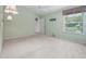 Bedroom featuring carpet, ceiling fan, and large window at 1889 Union Pl, The Villages, FL 32162