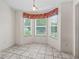 Bright breakfast nook with tiled floors and large windows offering outdoor views at 1889 Union Pl, The Villages, FL 32162