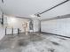 Spacious garage featuring washer, dryer, water heater, sink, and ample white cabinet storage at 1889 Union Pl, The Villages, FL 32162