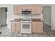 Kitchen with gas range, granite countertops, and light wood cabinets at 1889 Union Pl, The Villages, FL 32162