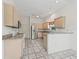 Bright kitchen featuring stainless steel appliances, tiled floors, and ample cabinet space at 1889 Union Pl, The Villages, FL 32162