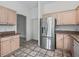 Kitchen featuring stainless steel refrigerator and light wood cabinets at 1889 Union Pl, The Villages, FL 32162
