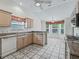 Kitchen featuring light wood cabinets, granite countertops and tiled floors, with breakfast nook at 1889 Union Pl, The Villages, FL 32162