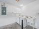 Laundry room featuring a washer, dryer, utility sink, cabinet, and electrical panel at 1889 Union Pl, The Villages, FL 32162
