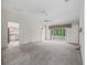 Spacious living room with high ceilings and sliding glass doors to the sunroom at 1889 Union Pl, The Villages, FL 32162