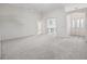 Bright living room with neutral carpet flooring and an open layout with views into the entry and adjoining spaces at 1889 Union Pl, The Villages, FL 32162