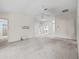 Spacious living room with neutral carpeting, ceiling fan, and adjacent rooms at 1889 Union Pl, The Villages, FL 32162