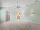 Empty main bedroom features carpet, ceiling fan, and access to ensuite bathroom at 1889 Union Pl, The Villages, FL 32162