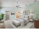 Spacious main bedroom featuring neutral carpet, ceiling fan, and ensuite bathroom at 1889 Union Pl, The Villages, FL 32162