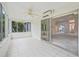 Bright sunroom with tiled floor and multiple windows leading to a view of the well-kept backyard at 1889 Union Pl, The Villages, FL 32162