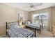 Cozy bedroom featuring two beds, neutral walls, a ceiling fan, and a window at 2055 Merideth Ter, The Villages, FL 34762