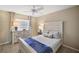 Comfortable bedroom with neutral decor, ceiling fan, and large dresser for ample storage at 2055 Merideth Ter, The Villages, FL 34762