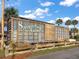 Rustic Sawgrass Grove train car attraction with palm trees set against a bright blue sky at 2055 Merideth Ter, The Villages, FL 34762