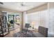 Sunroom with view of patio and backyard featuring comfortable seating and natural light at 2055 Merideth Ter, The Villages, FL 34762
