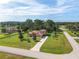 A serene aerial view showcases a beautiful home nestled among mature trees, green lawns, and lush landscaping at 21312 Marsh View Ct, Clermont, FL 34715