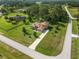 An aerial view showcases this home with its long driveway and a private screened-in pool at 21312 Marsh View Ct, Clermont, FL 34715