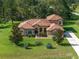 An aerial view highlights this home with its well-manicured lawn, mature trees, and a long private driveway at 21312 Marsh View Ct, Clermont, FL 34715
